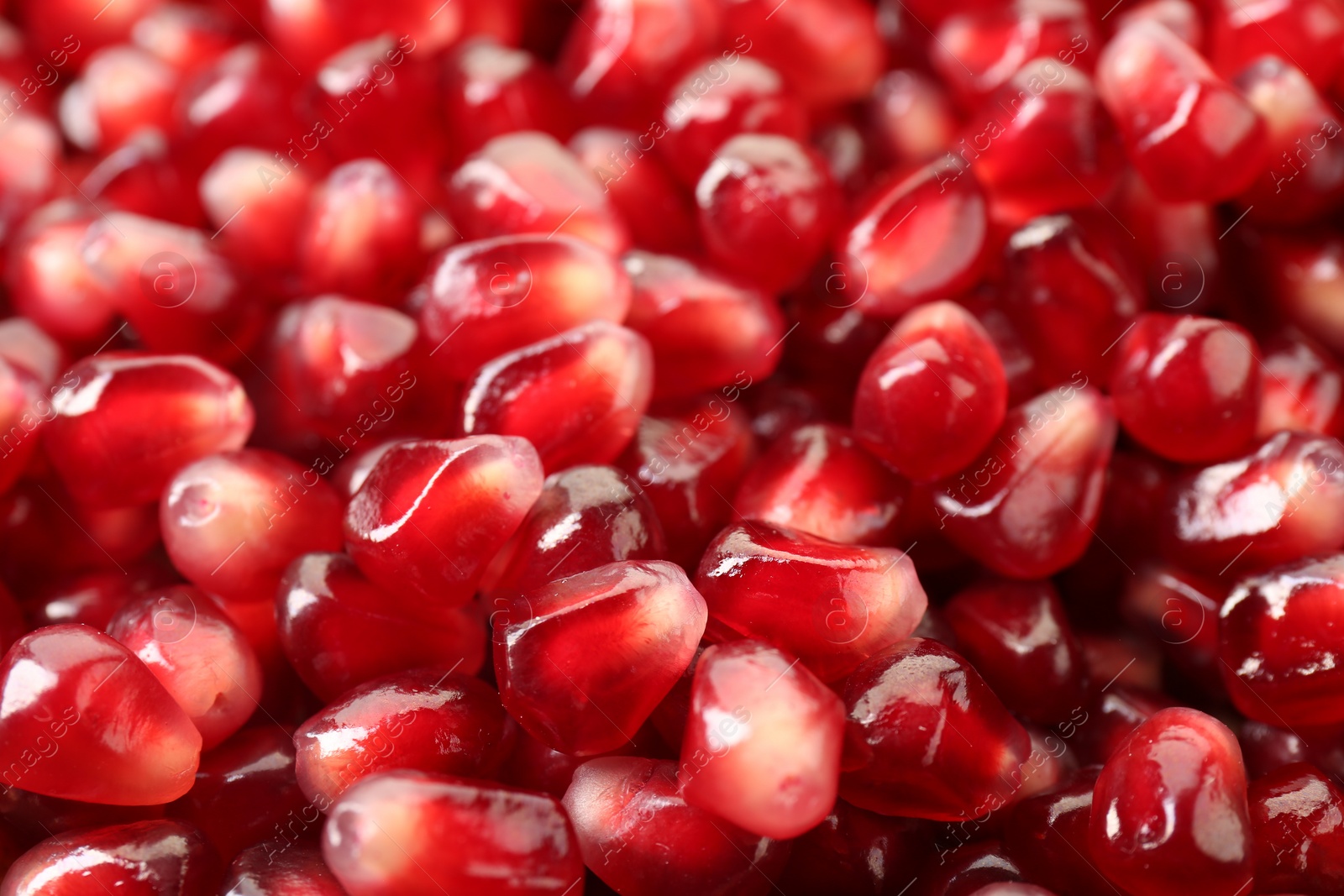 Photo of Ripe juicy pomegranate grains as background, closeup