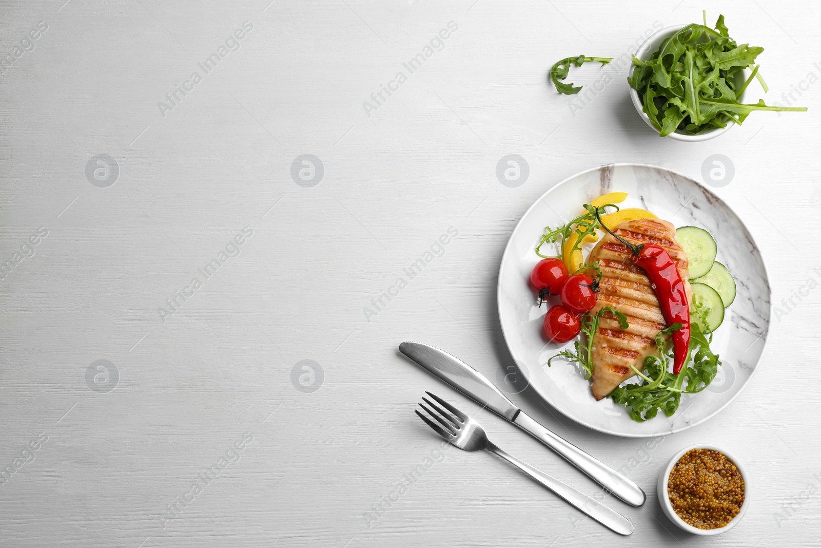 Photo of Tasty grilled chicken fillet served on white wooden table, flat lay. Space for text