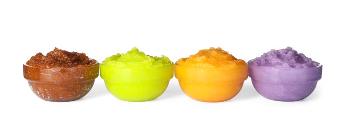 Different body scrubs in bowls on white background