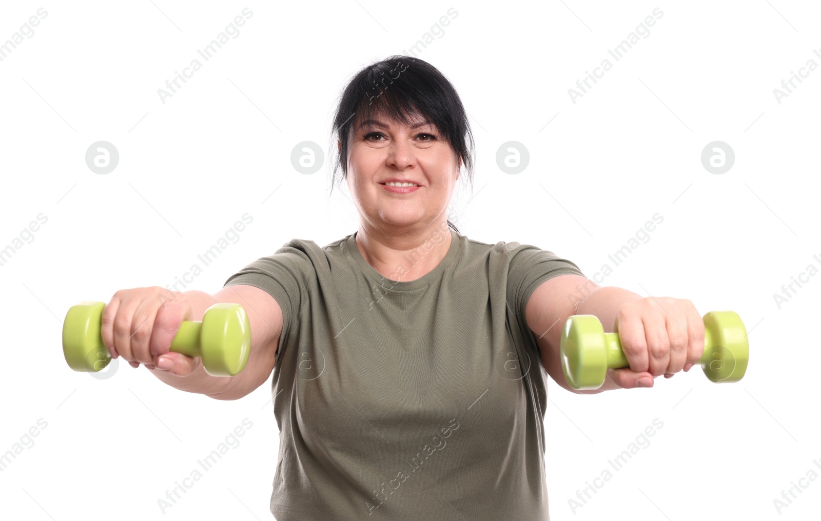 Photo of Happy overweight mature woman doing exercise with dumbbells on white background