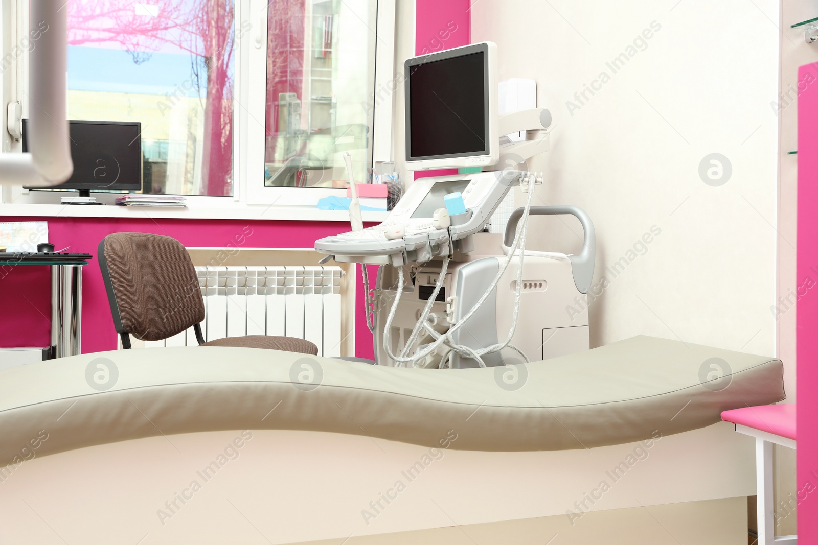 Photo of Examination room with modern ultrasound machine in clinic