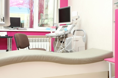 Photo of Examination room with modern ultrasound machine in clinic