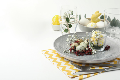 Festive Easter table setting with beautiful floral decor. Space for text