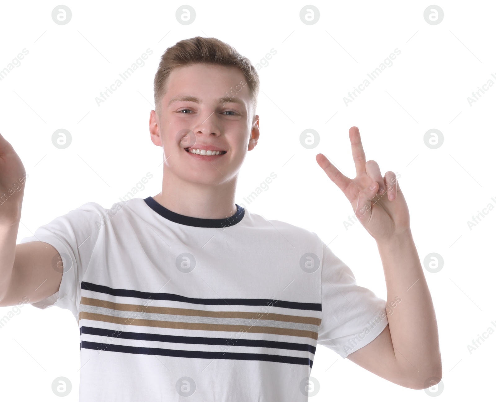 Photo of Happy teenage boy taking selfie on white background