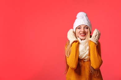 Portrait of emotional young woman in stylish clothes on color background, space for text. Winter atmosphere