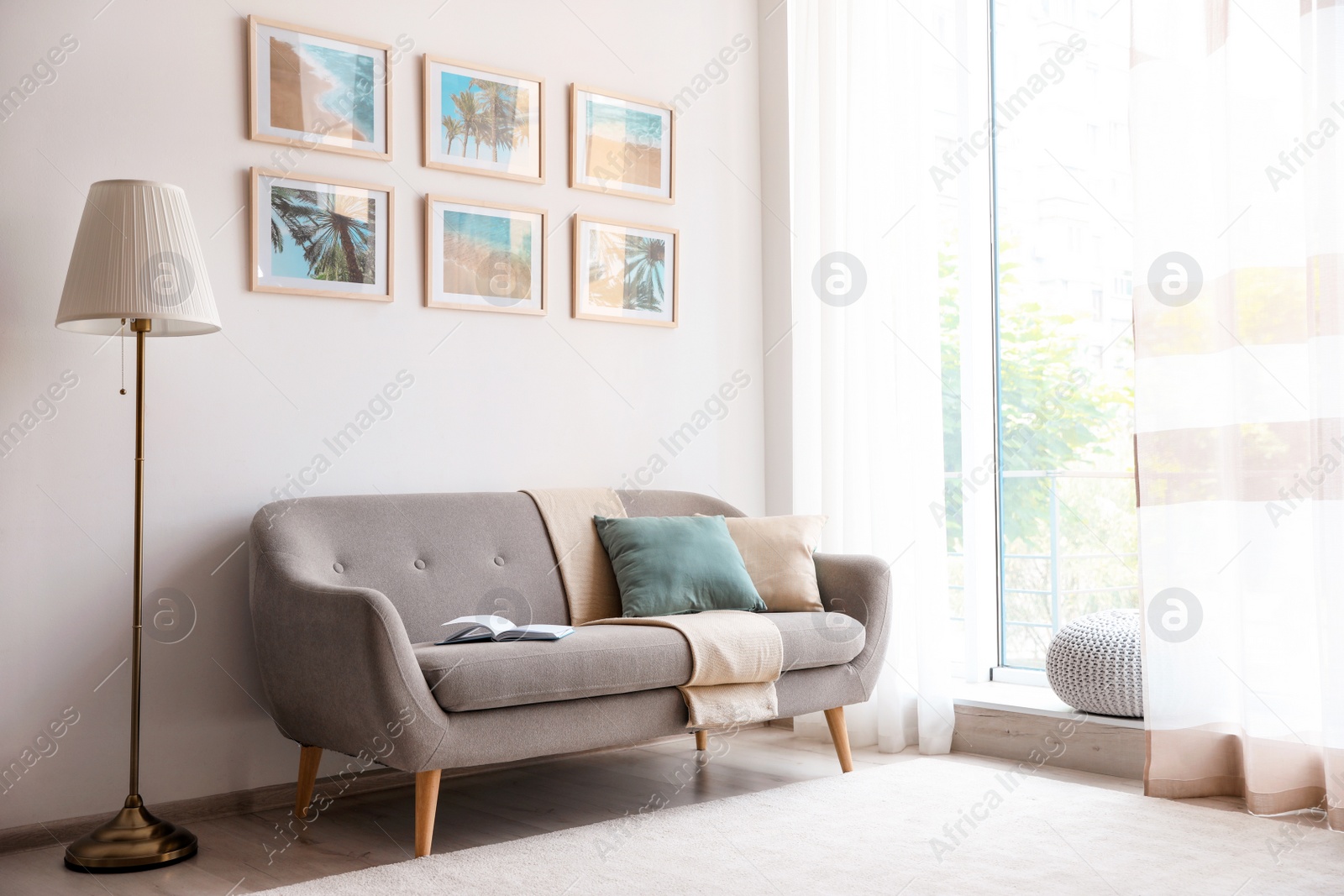 Photo of Stylish room interior with trendy furniture and pictures on wall