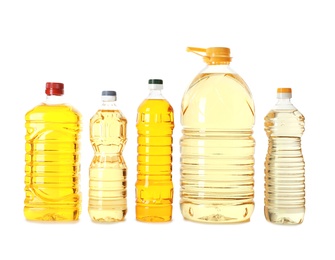 Photo of Different plastic bottles with oils on white background