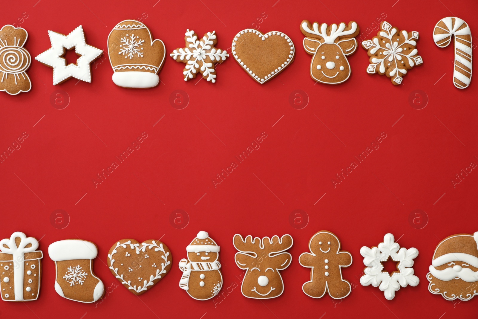 Photo of Different Christmas gingerbread cookies on red background, flat lay. Space for text