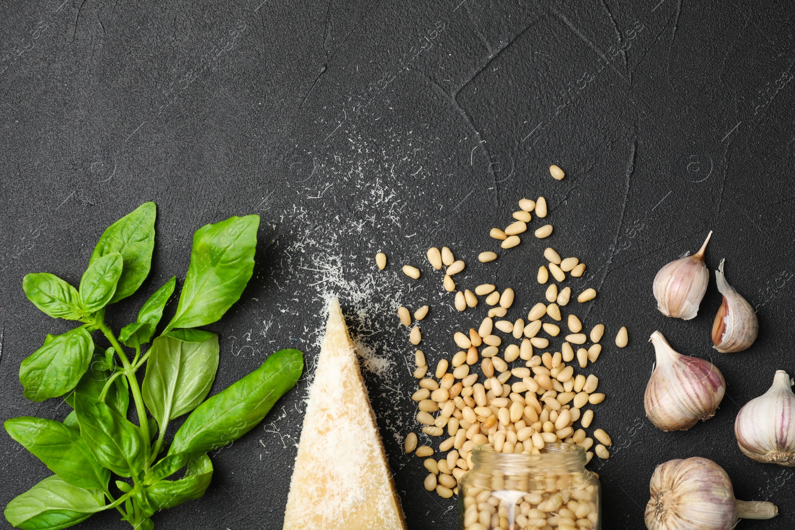 Photo of Flat lay composition with products and space for text on black background. Basil pesto sauce recipe