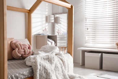 Cozy child room interior with comfortable bed