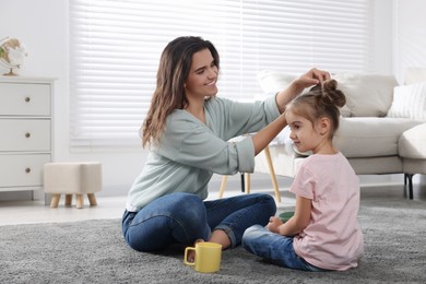 Young mother and her daughter spending time together at home