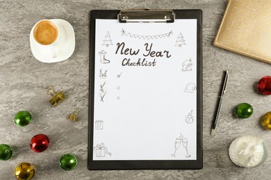 Photo of New Year Checklist. Flat lay composition with clipboard and festive decor on grey background