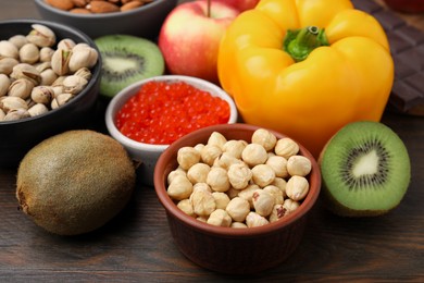 Photo of Many different products on wooden table, closeup. Natural sources of serotonin