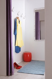 Photo of Empty dressing room in fashion store. Stylish interior