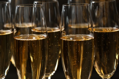 Photo of Many glasses of champagne as background, closeup view