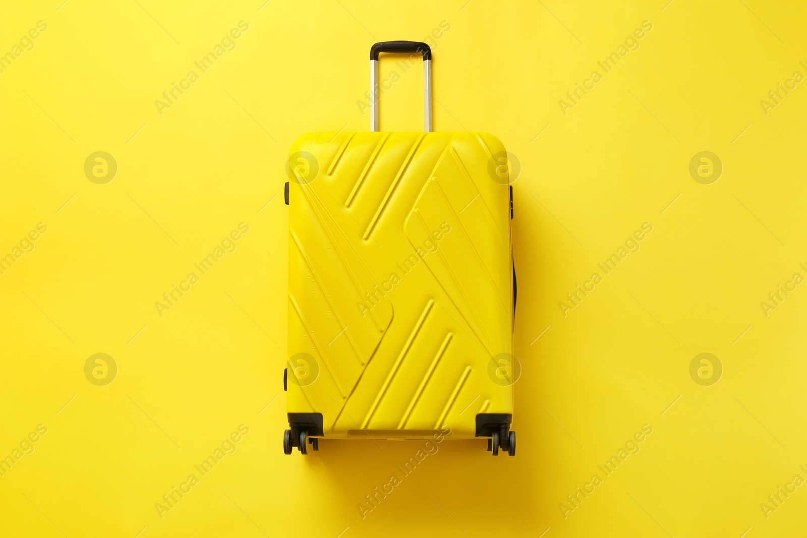 Photo of Stylish suitcase on color background, top view