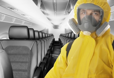 Image of Man wearing protective suit cleaning cabin in airplane to prevent spreading of Coronavirus
