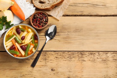 Bowl of delicious turnip soup served on wooden table, flat lay. Space for text