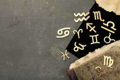 Zodiac signs, old book and letter on grey textured table, flat lay. Space for text