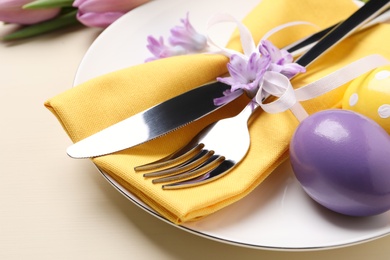 Photo of Festive Easter table setting with eggs on beige background, closeup