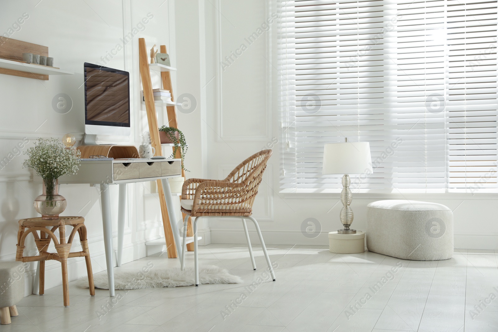 Photo of Comfortable workplace with modern computer and lamp in room. Interior design