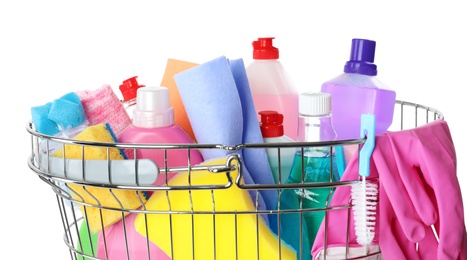 Metal shopping basket with different household chemicals on white background