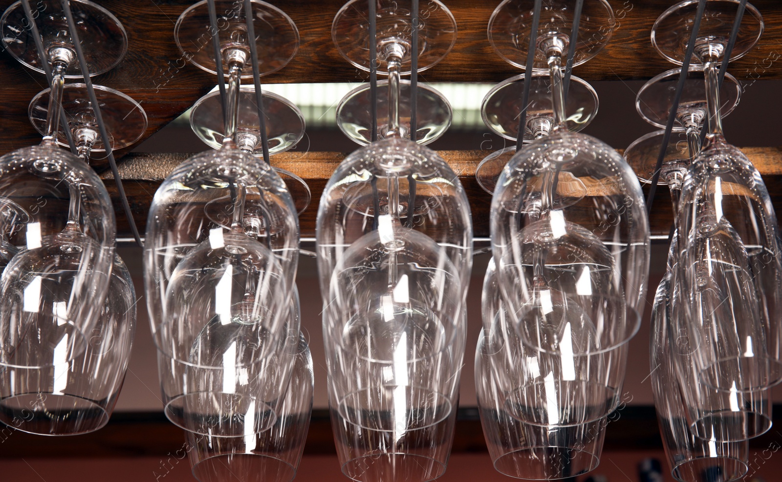 Photo of Clean glasses hanging over counter in bar