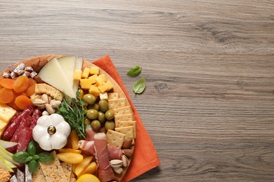 Photo of Different tasty appetizers on wooden table, flat lay. Space for text