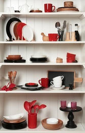 Photo of White shelving unit with set of dishware