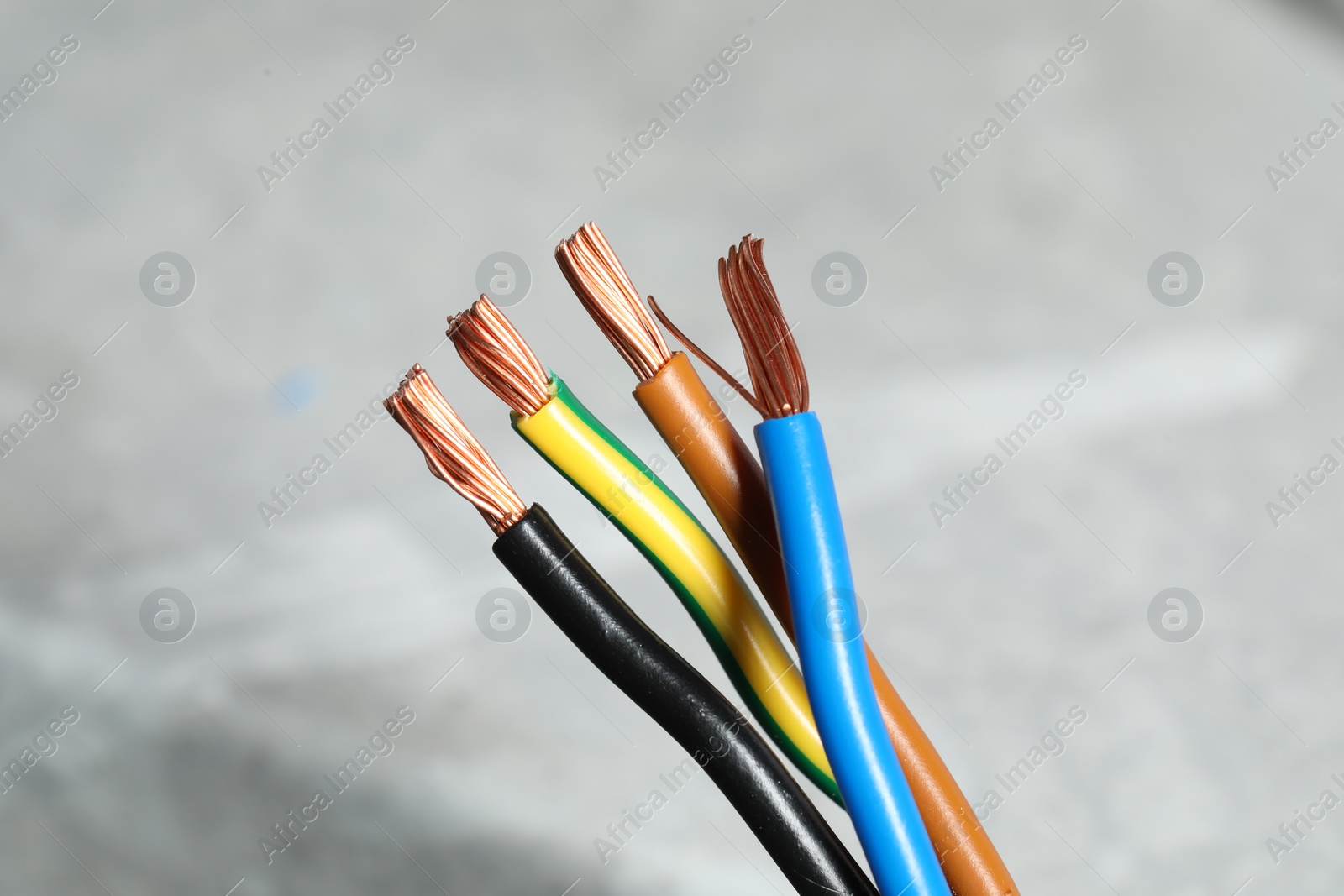 Photo of Colorful electrical wires on blurred background, closeup