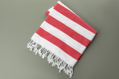Photo of Folded striped beach towel on grey background, top view