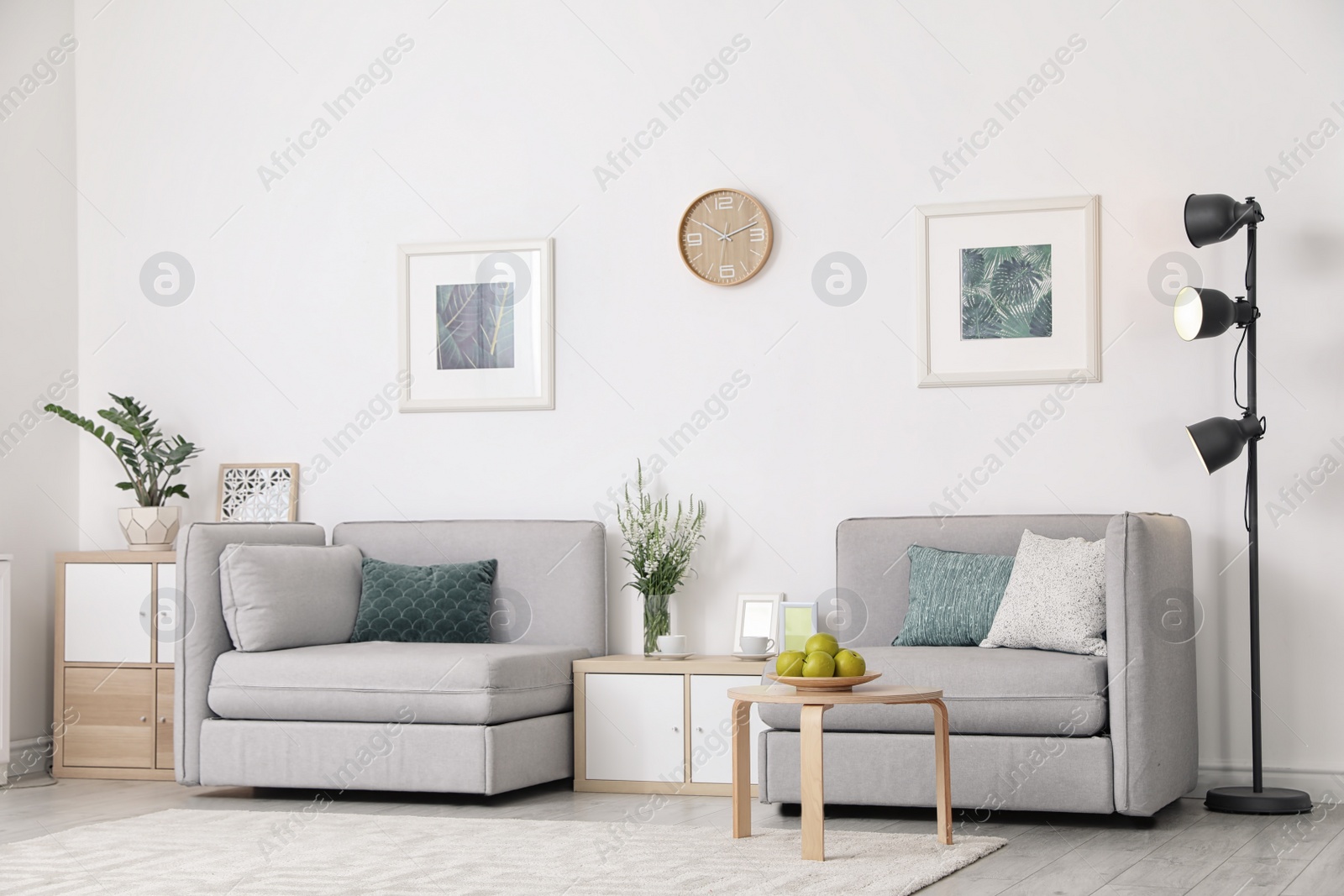 Photo of Modern interior of living room with comfortable armchairs near white wall