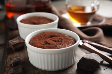 Photo of Delicious fresh chocolate fondant on wooden board, closeup