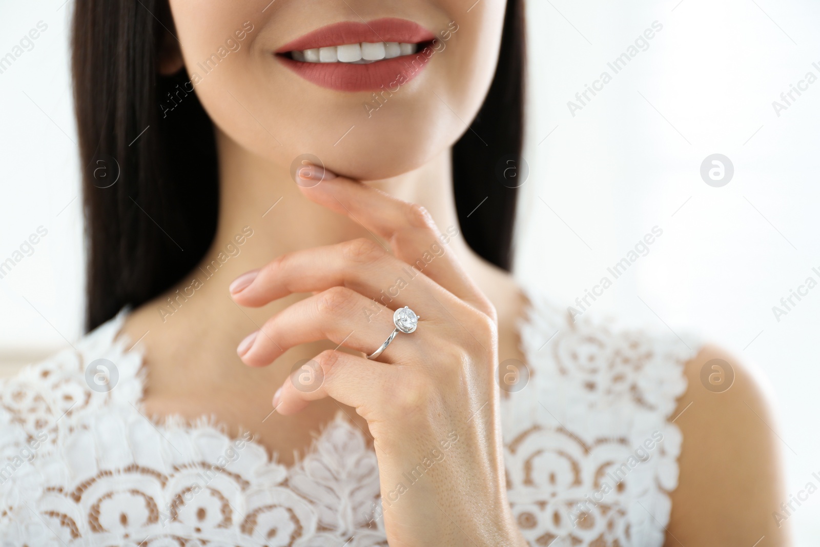 Photo of Young bride wearing beautiful engagement ring, closeup