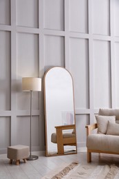 Light room interior with large mirror near wall