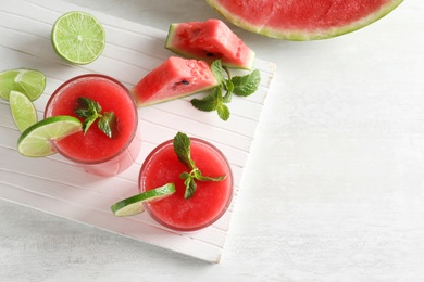 Tasty summer watermelon drink in glasses served on table with space for text, top view