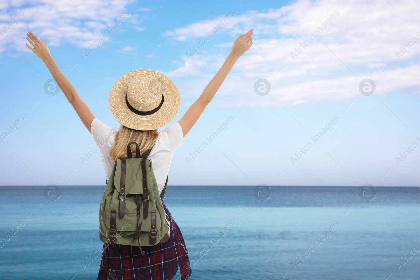 Image of Traveler with backpack near sea during summer vacation trip, back view. Space for text