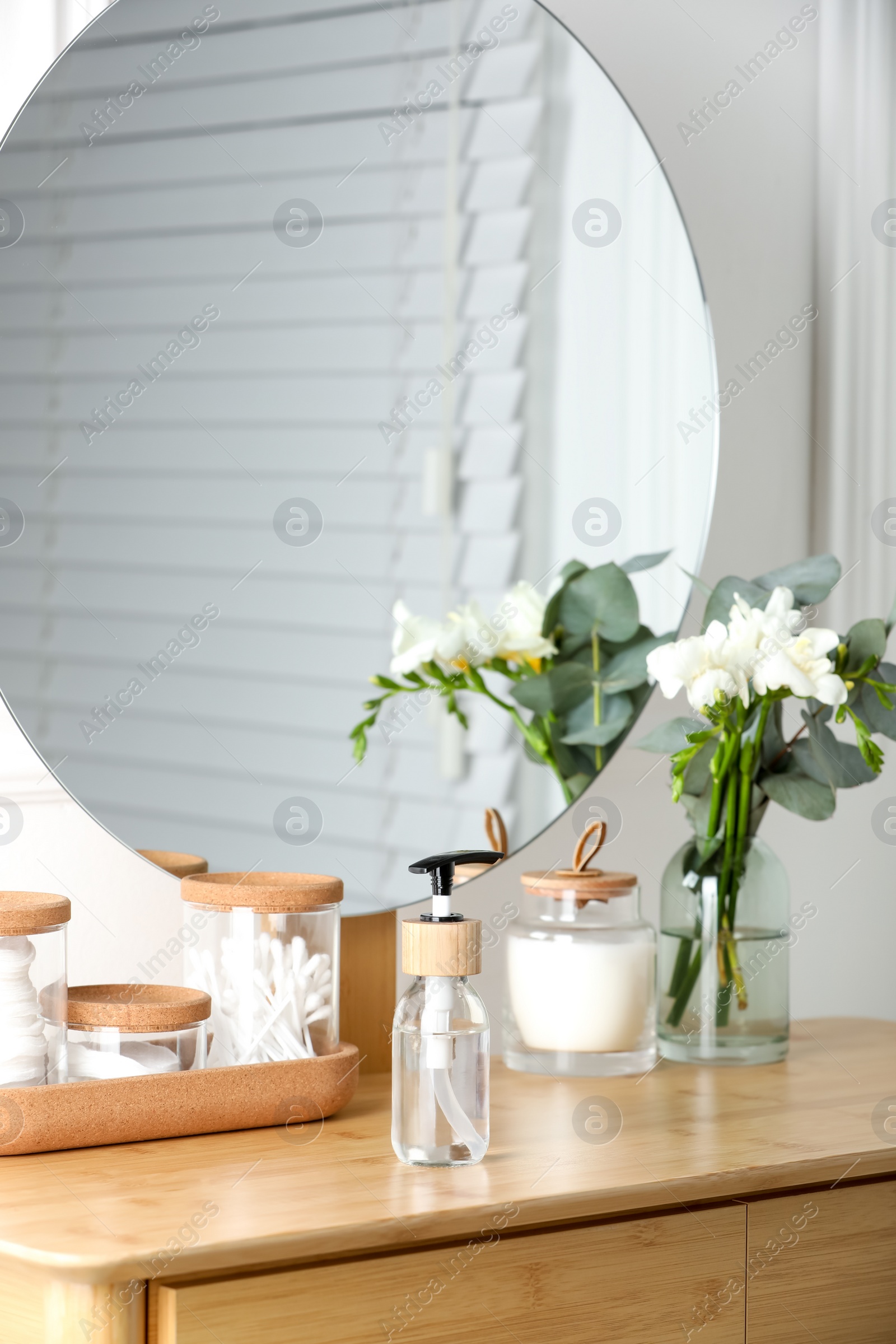 Photo of Bottle with dispenser cap on wooden table indoors