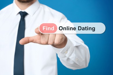 Man pointing at search bar with request Online Dating on blue background, closeup