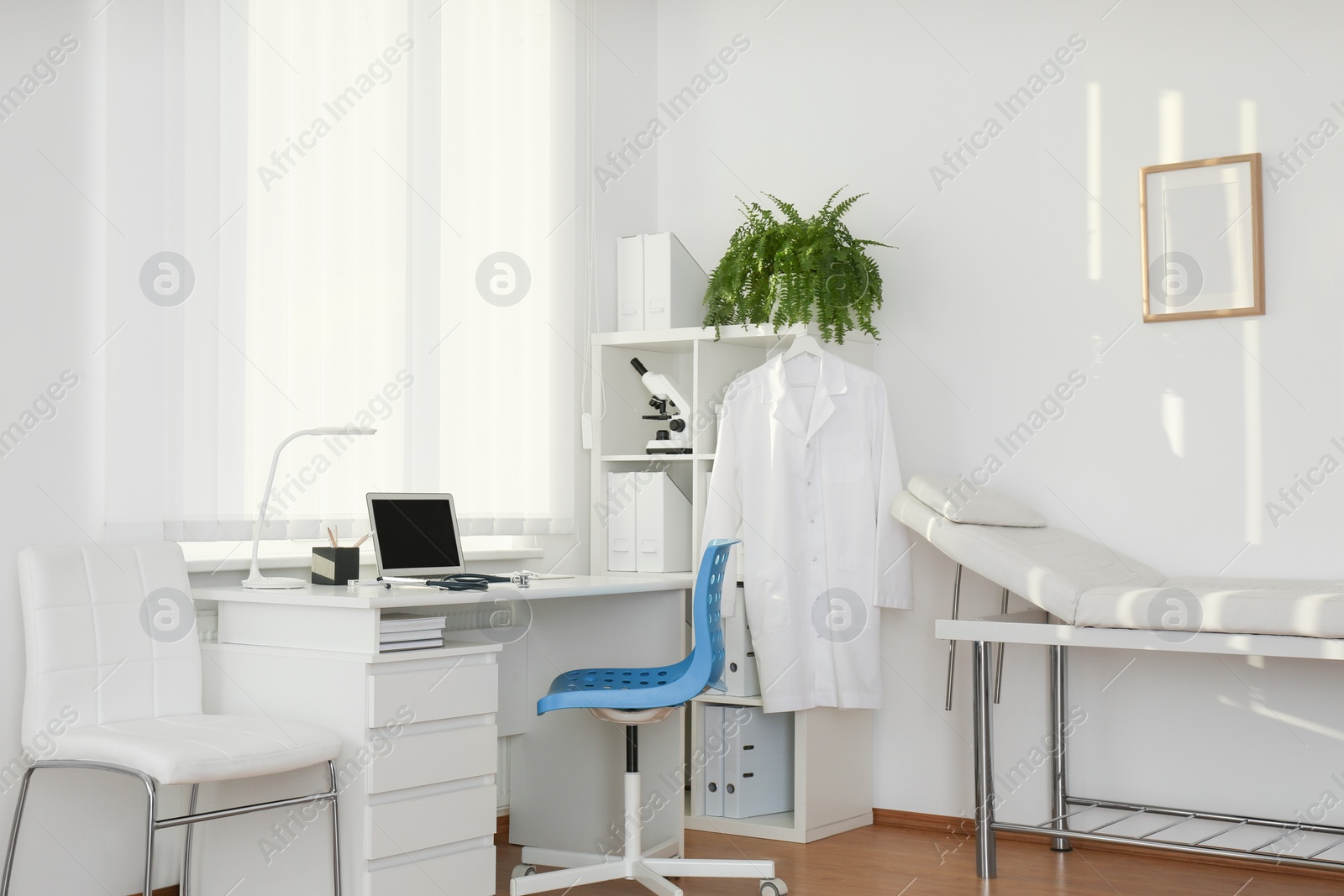 Photo of Interior of modern medical office with doctor's workplace