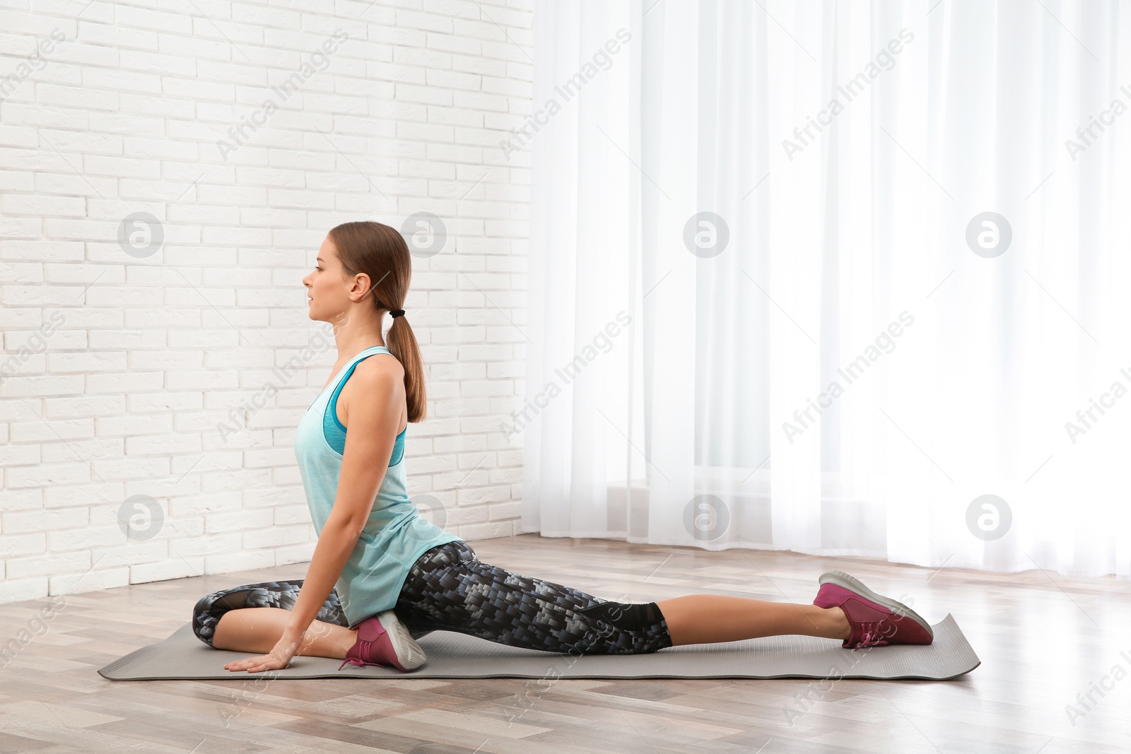 Photo of Young woman doing fitness exercises at home