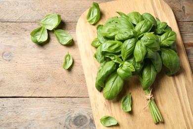 Photo of Fresh basil on wooden table, flat lay