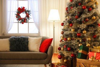 Image of Beautiful Christmas tree in living room. Festive interior