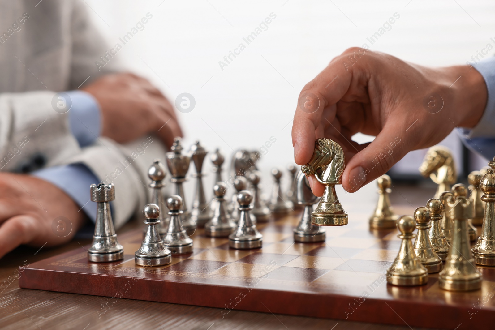 Photo of Men playing chess during tournament at table, closeup