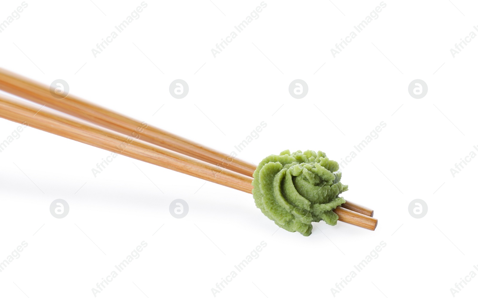 Photo of Chopsticks with swirl of wasabi paste isolated on white