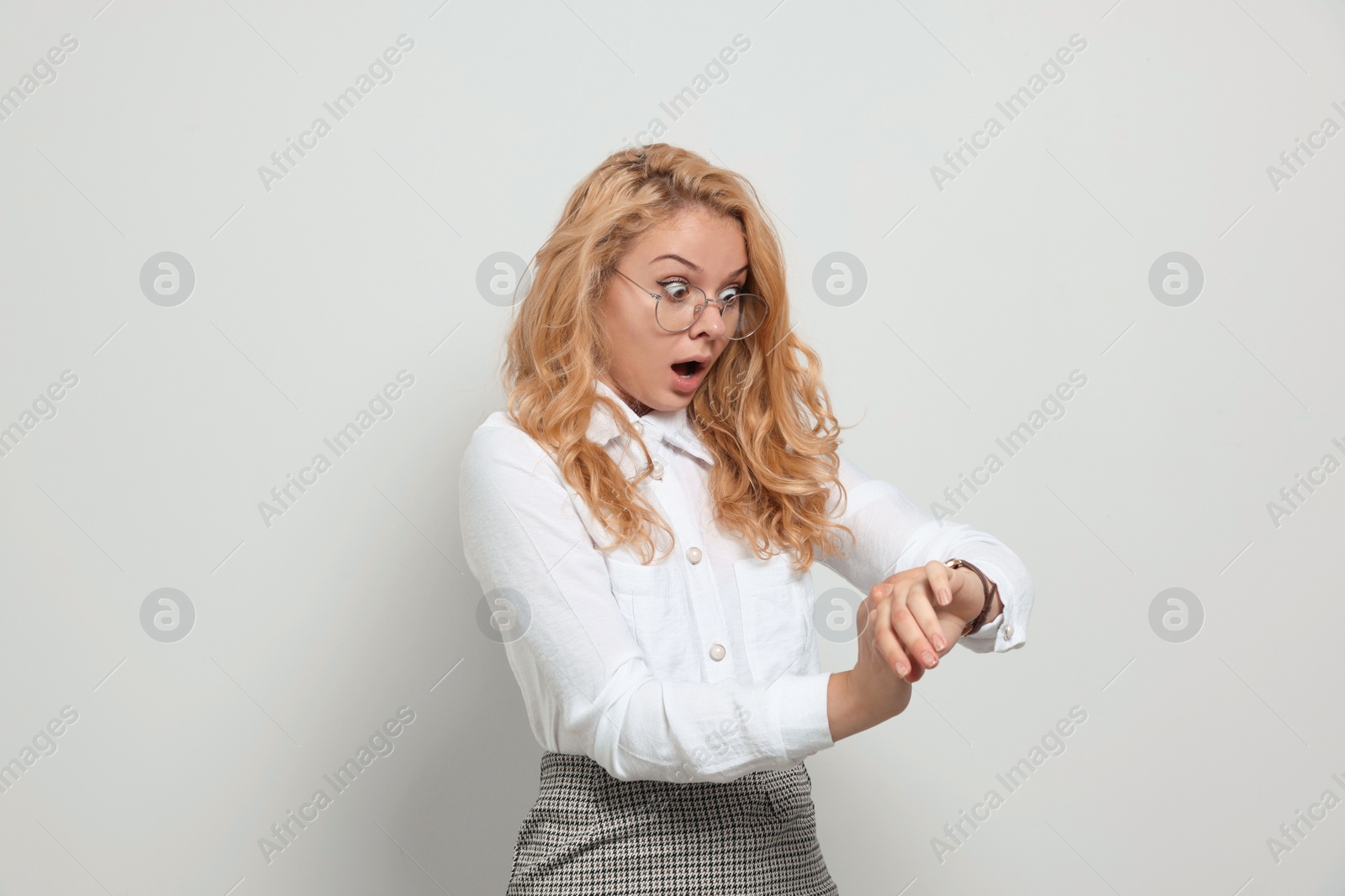 Photo of Emotional businesswoman in turmoil over being late on white background