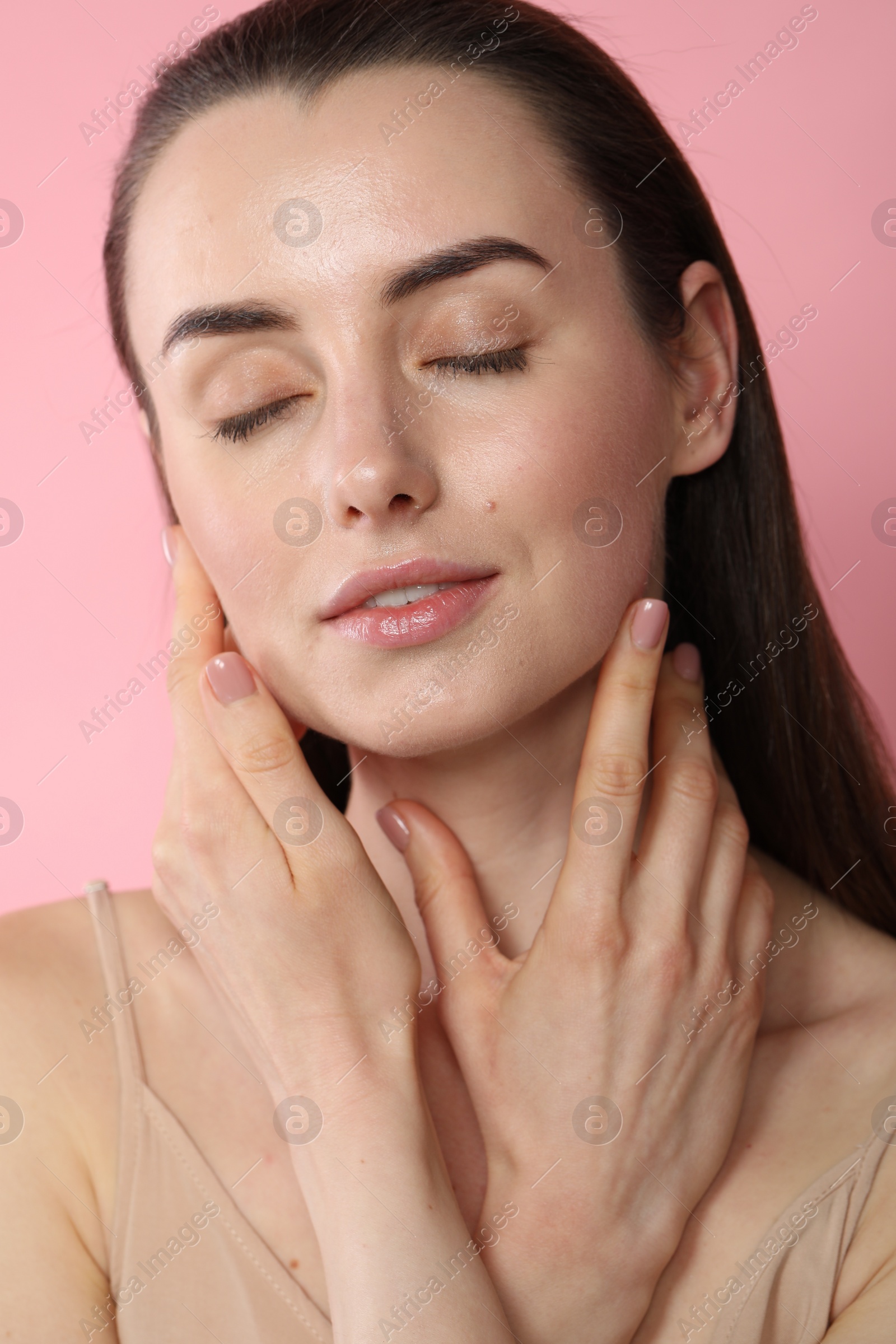 Photo of Portrait of beautiful young woman on pink background