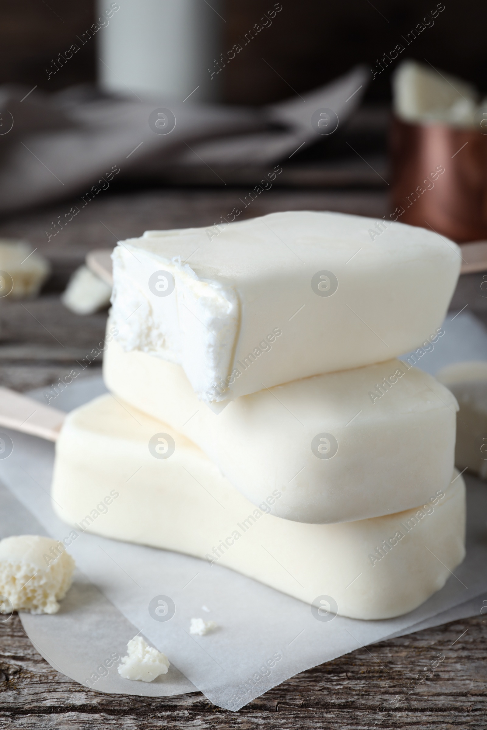 Photo of Delicious glazed ice cream bars on wooden table, closeup