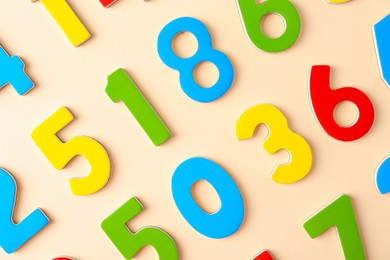 Photo of Colorful numbers on beige background, flat lay