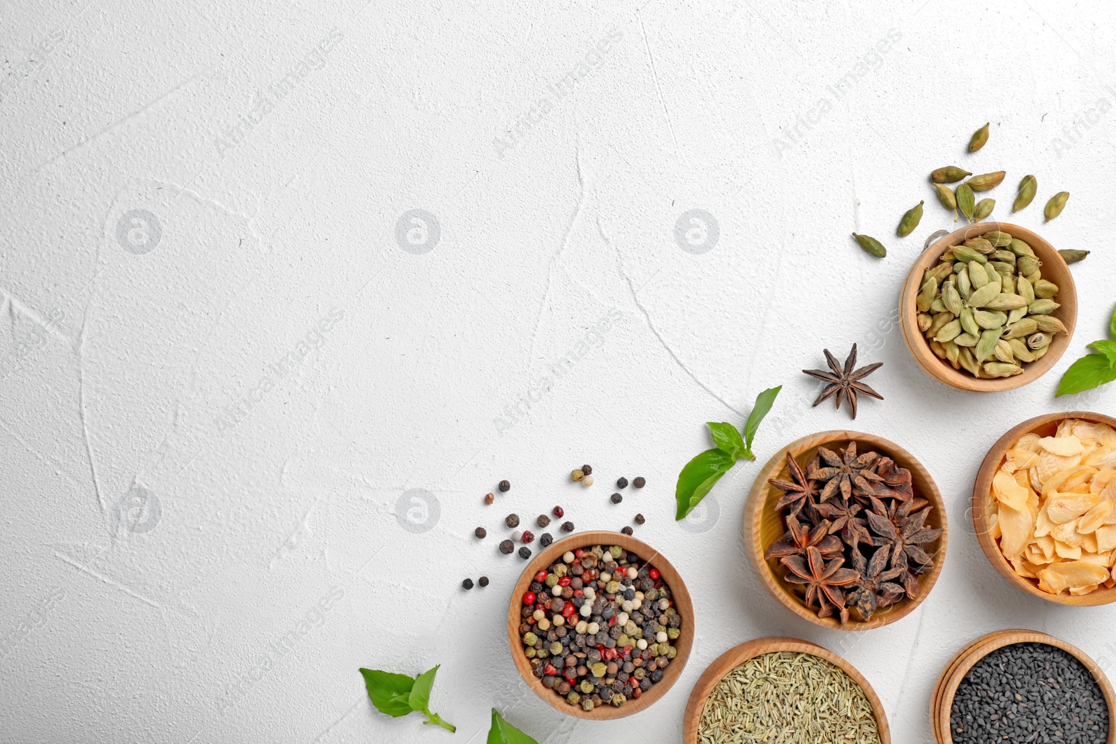 Photo of Flat lay composition with different aromatic spices and space for text on light background